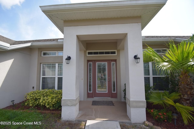 doorway to property with stucco siding