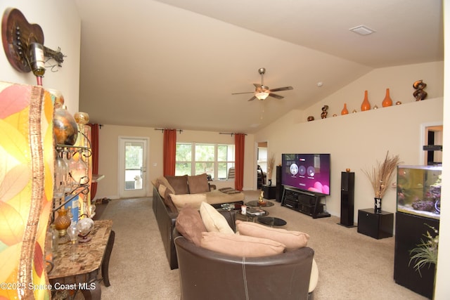 carpeted living room featuring vaulted ceiling and a ceiling fan