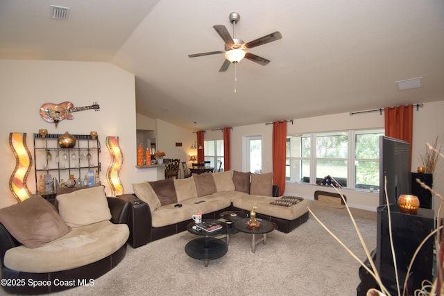 carpeted living room with vaulted ceiling and a ceiling fan