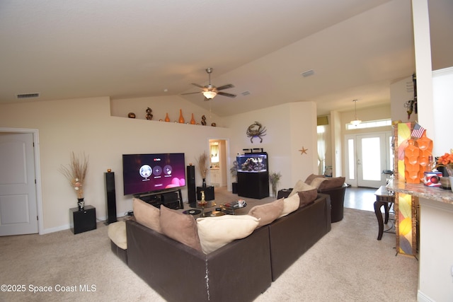 carpeted living area with a ceiling fan and vaulted ceiling