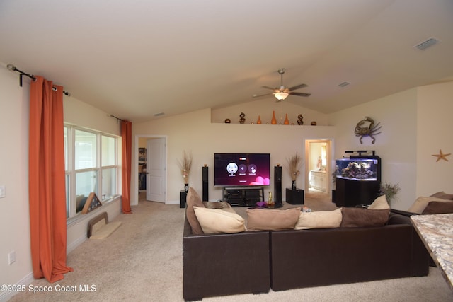 living room featuring ceiling fan, light carpet, and vaulted ceiling