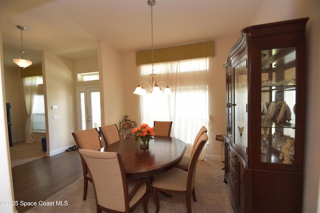 dining room with baseboards, dark wood-style floors, and a chandelier