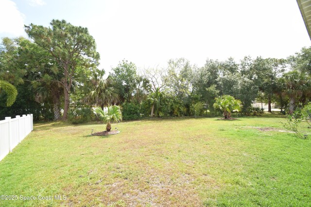 view of yard with view of wooded area