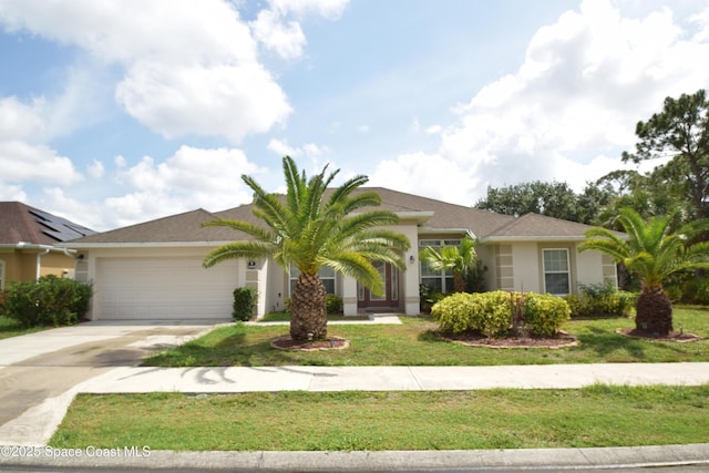view of front of property with an attached garage, concrete driveway, stucco siding, and a front yard