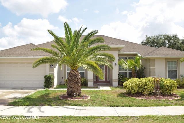 view of front facade with an attached garage, stucco siding, concrete driveway, and a front yard