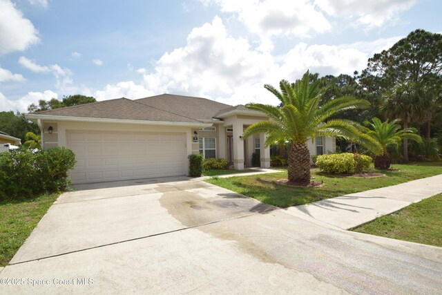 view of front of property with driveway, an attached garage, stucco siding, and a front lawn