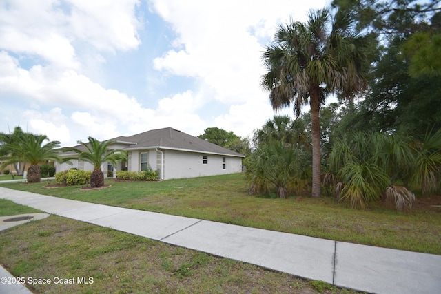 view of property exterior with a yard