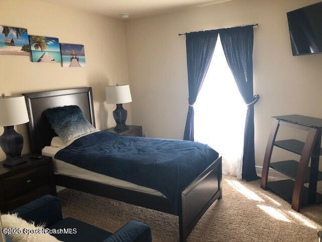bedroom featuring carpet
