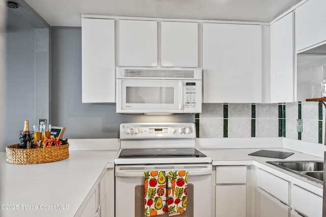 55 Riverside Dr Unit 103, Cocoa, FL 32922 - kitchen with white appliances, light countertops, and white cabinets