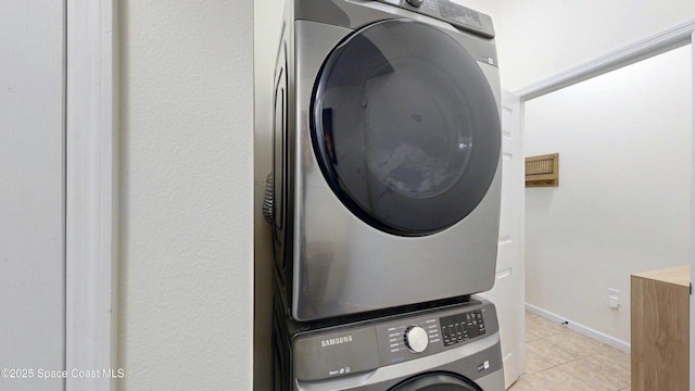 4047 Meander Pl Unit 205, Rockledge, FL 32955 - washroom with stacked washer and clothes dryer and light tile patterned floors