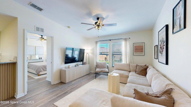 4047 Meander Pl Unit 205, Rockledge, FL 32955 - living room featuring a ceiling fan, light wood-type flooring, and baseboards