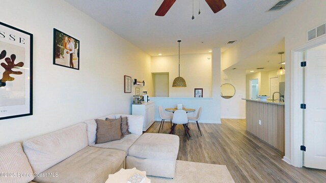 4047 Meander Pl Unit 205, Rockledge, FL 32955 - living area featuring wood finished floors, ceiling fan, and baseboards