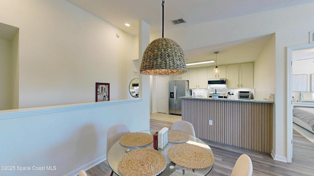 4047 Meander Pl Unit 205, Rockledge, FL 32955 - dining room featuring light wood finished floors, baseboards, and recessed lighting