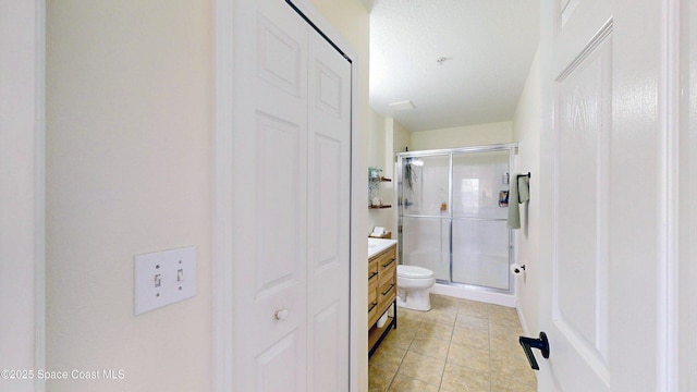 4047 Meander Pl Unit 205, Rockledge, FL 32955 - bathroom featuring vanity, a stall shower, tile patterned flooring, and toilet