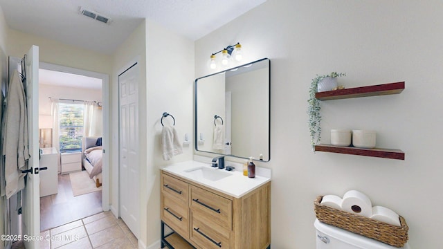 4047 Meander Pl Unit 205, Rockledge, FL 32955 - bathroom with vanity, tile patterned floors, toilet, and ensuite bathroom