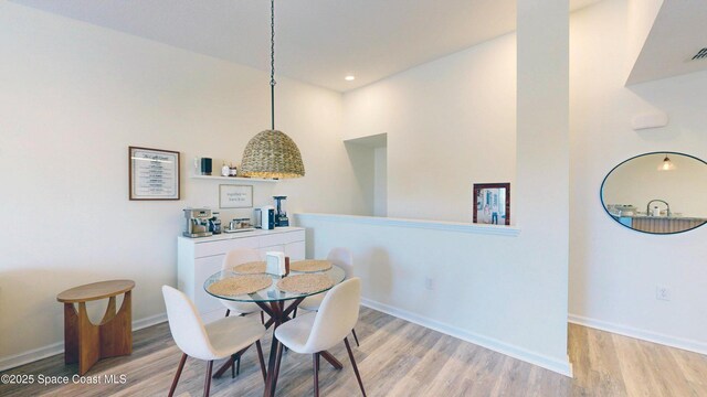 4047 Meander Pl Unit 205, Rockledge, FL 32955 - dining area featuring light wood-style flooring, baseboards, and recessed lighting