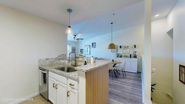 4047 Meander Pl Unit 205, Rockledge, FL 32955 - kitchen featuring a sink, dishwasher, a peninsula, ceiling fan, and light stone counters