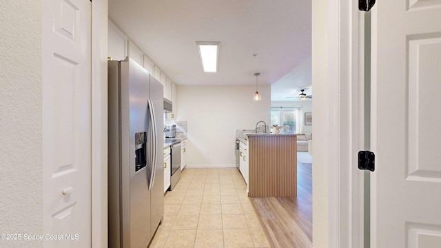 4047 Meander Pl Unit 205, Rockledge, FL 32955 - kitchen with appliances with stainless steel finishes, a peninsula, a ceiling fan, a sink, and hanging light fixtures