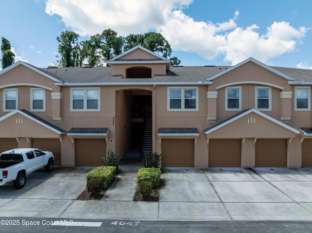 4047 Meander Pl Unit 205, Rockledge, FL 32955 - multi unit property with an attached garage, stucco siding, driveway, and a shingled roof