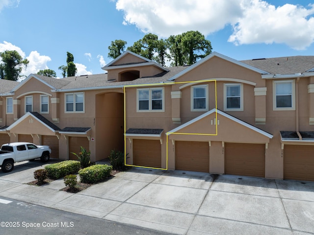 4047 Meander Pl Unit 205, Rockledge, FL 32955 - view of property with a garage, stucco siding, and driveway