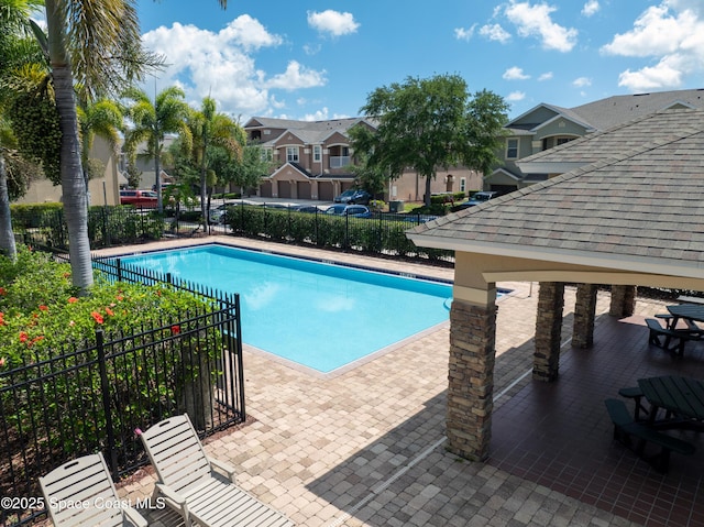 4047 Meander Pl Unit 205, Rockledge, FL 32955 - community pool with fence, a residential view, and a patio