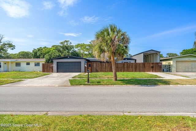 view of front facade with concrete driveway, a carport, and a garage
