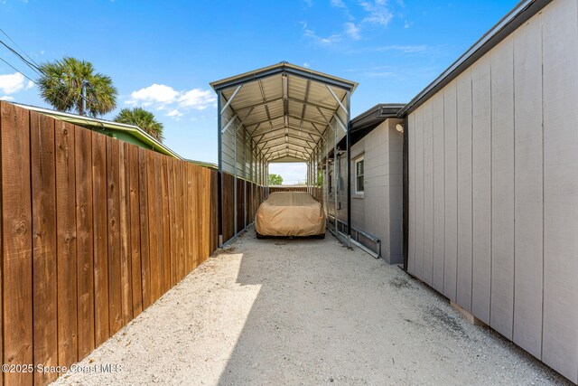 view of side of property featuring a detached carport and fence