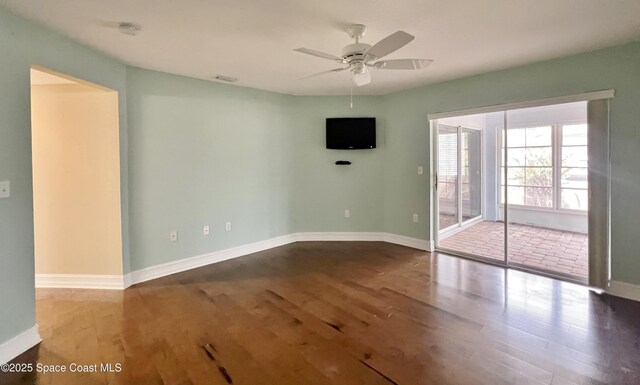 unfurnished room with wood finished floors and baseboards