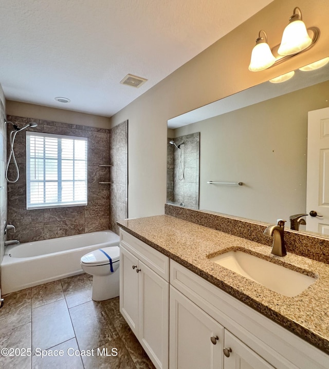 full bath featuring toilet, shower / tub combination, vanity, and tile patterned flooring