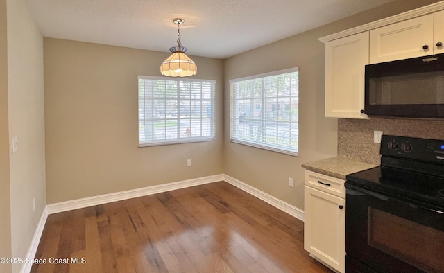 kitchen with black appliances, baseboards, dark wood-style flooring, white cabinetry, and tasteful backsplash