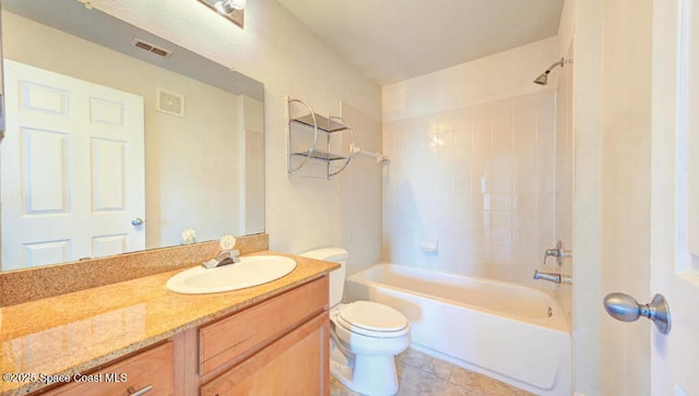 bathroom with toilet, tile patterned flooring, vanity, and bathing tub / shower combination