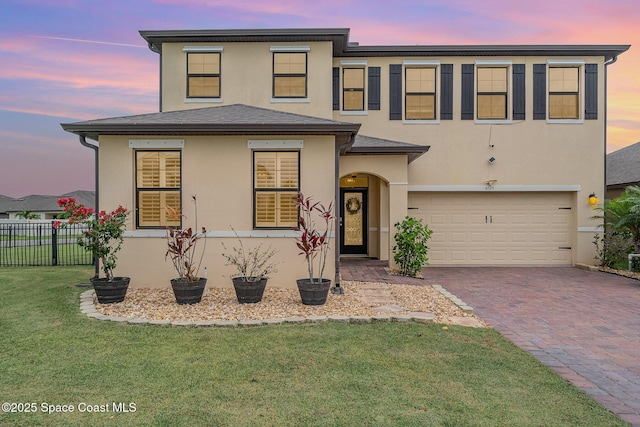 4109 Alligator Flag Cir, West Melbourne, FL 32904 - view of front facade with an attached garage, stucco siding, and decorative driveway