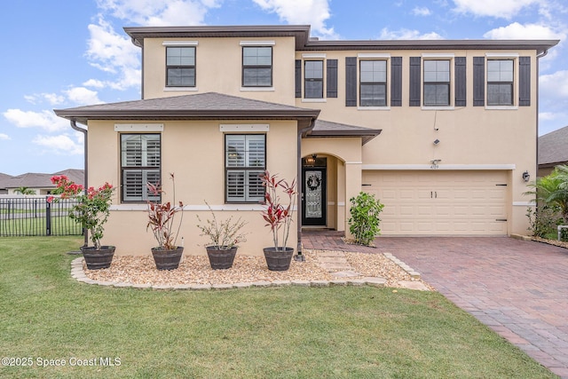 4109 Alligator Flag Cir, West Melbourne, FL 32904 - view of front of house featuring an attached garage, stucco siding, and decorative driveway