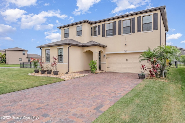 4109 Alligator Flag Cir, West Melbourne, FL 32904 - view of front of house featuring a garage, stucco siding, and decorative driveway