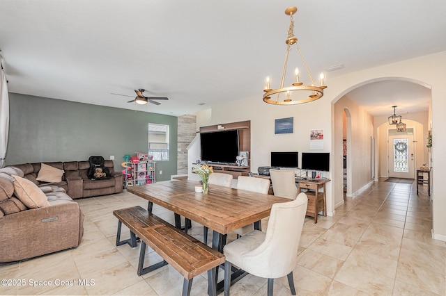 4109 Alligator Flag Cir, West Melbourne, FL 32904 - dining space with arched walkways, a ceiling fan, healthy amount of natural light, and a chandelier