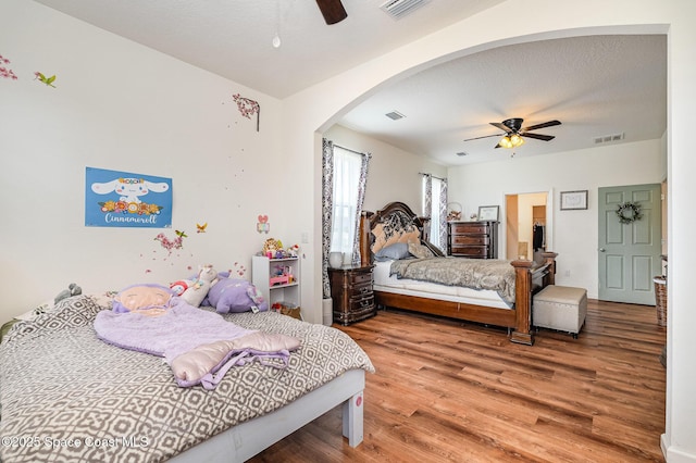 4109 Alligator Flag Cir, West Melbourne, FL 32904 - bedroom with wood finished floors, arched walkways, and a ceiling fan
