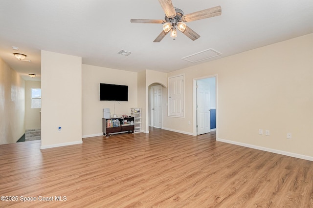 4109 Alligator Flag Cir, West Melbourne, FL 32904 - unfurnished living room with light wood-style floors, arched walkways, baseboards, and a ceiling fan