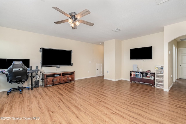 4109 Alligator Flag Cir, West Melbourne, FL 32904 - living room with light wood finished floors, a ceiling fan, arched walkways, and baseboards