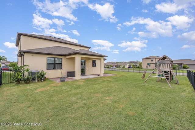4109 Alligator Flag Cir, West Melbourne, FL 32904 - back of house featuring a playground, a patio, stucco siding, and cooling unit
