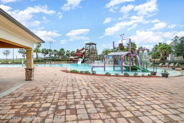 4109 Alligator Flag Cir, West Melbourne, FL 32904 - community pool featuring a water play area, a water slide, and a patio area