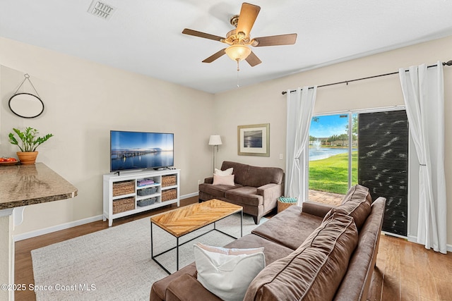 2650 Revolution St Unit 103, Melbourne, FL 32935 - living room with wood finished floors, a ceiling fan, and baseboards