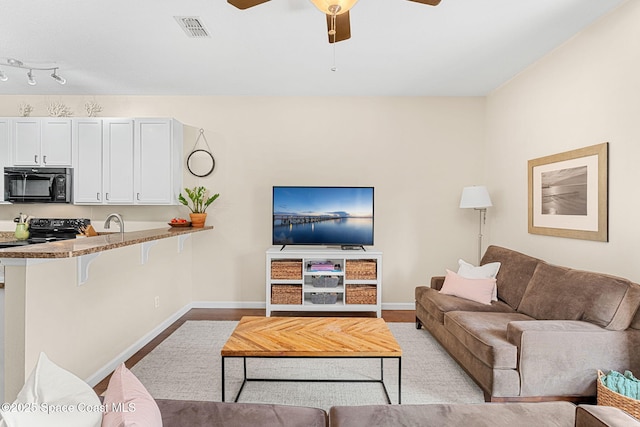 2650 Revolution St Unit 103, Melbourne, FL 32935 - living room with ceiling fan and baseboards