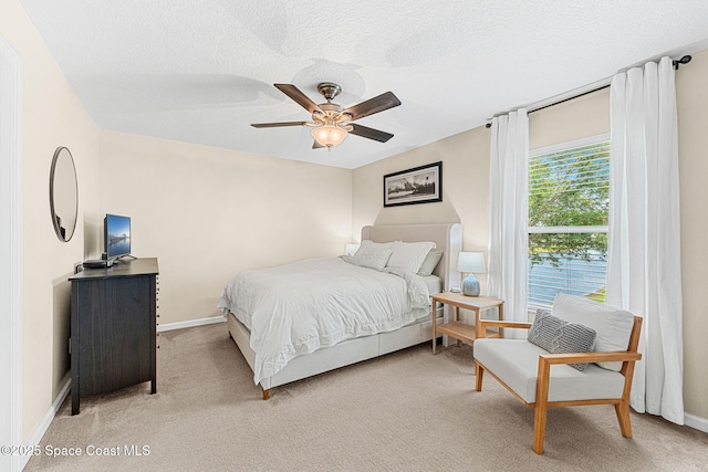 2650 Revolution St Unit 103, Melbourne, FL 32935 - bedroom featuring light colored carpet, baseboards, ceiling fan, and a textured ceiling