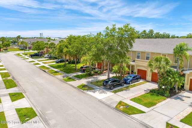 2650 Revolution St Unit 103, Melbourne, FL 32935 - view of front of house featuring concrete driveway, an attached garage, a residential view, and stucco siding