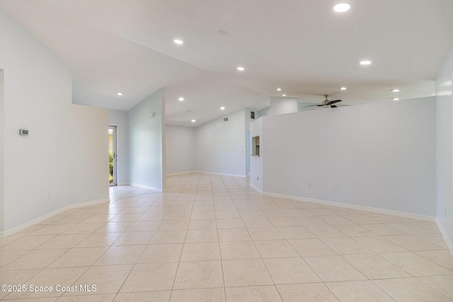 spare room with recessed lighting, vaulted ceiling, light tile patterned flooring, baseboards, and ceiling fan