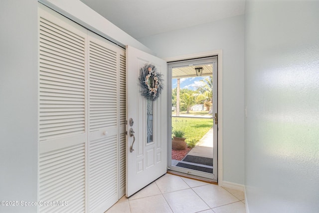 entryway featuring light tile patterned floors and baseboards