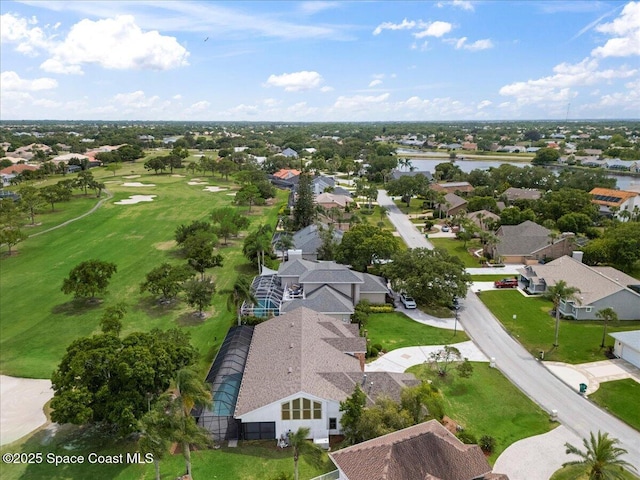 aerial view of residential area with a nearby body of water and a golf course