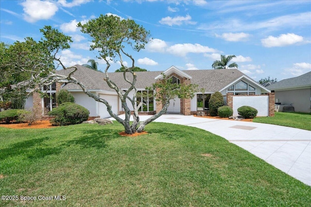 649 Spring Lake Dr, Melbourne, FL 32940 - view of front of property featuring driveway, a front yard, an attached garage, and roof with shingles