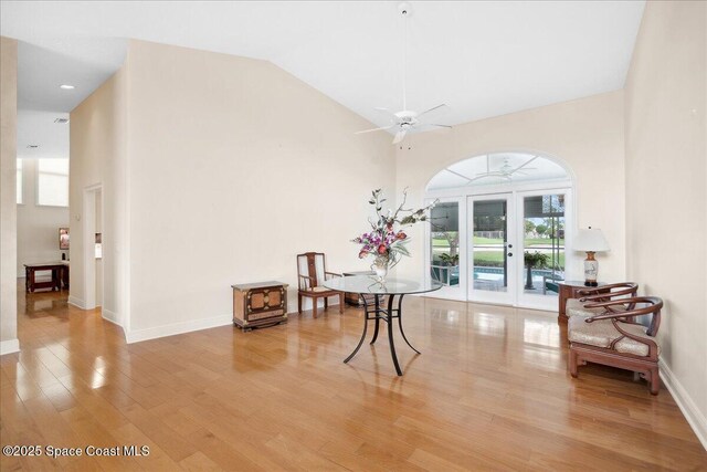 649 Spring Lake Dr, Melbourne, FL 32940 - dining room featuring light wood finished floors, a towering ceiling, ceiling fan, french doors, and baseboards