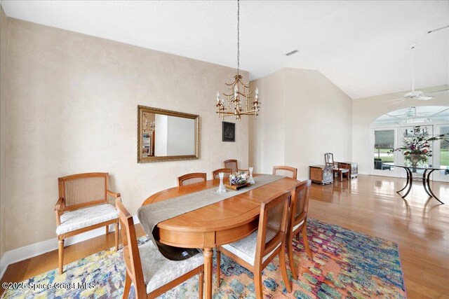 649 Spring Lake Dr, Melbourne, FL 32940 - dining area featuring wood finished floors, a ceiling fan, baseboards, and a chandelier